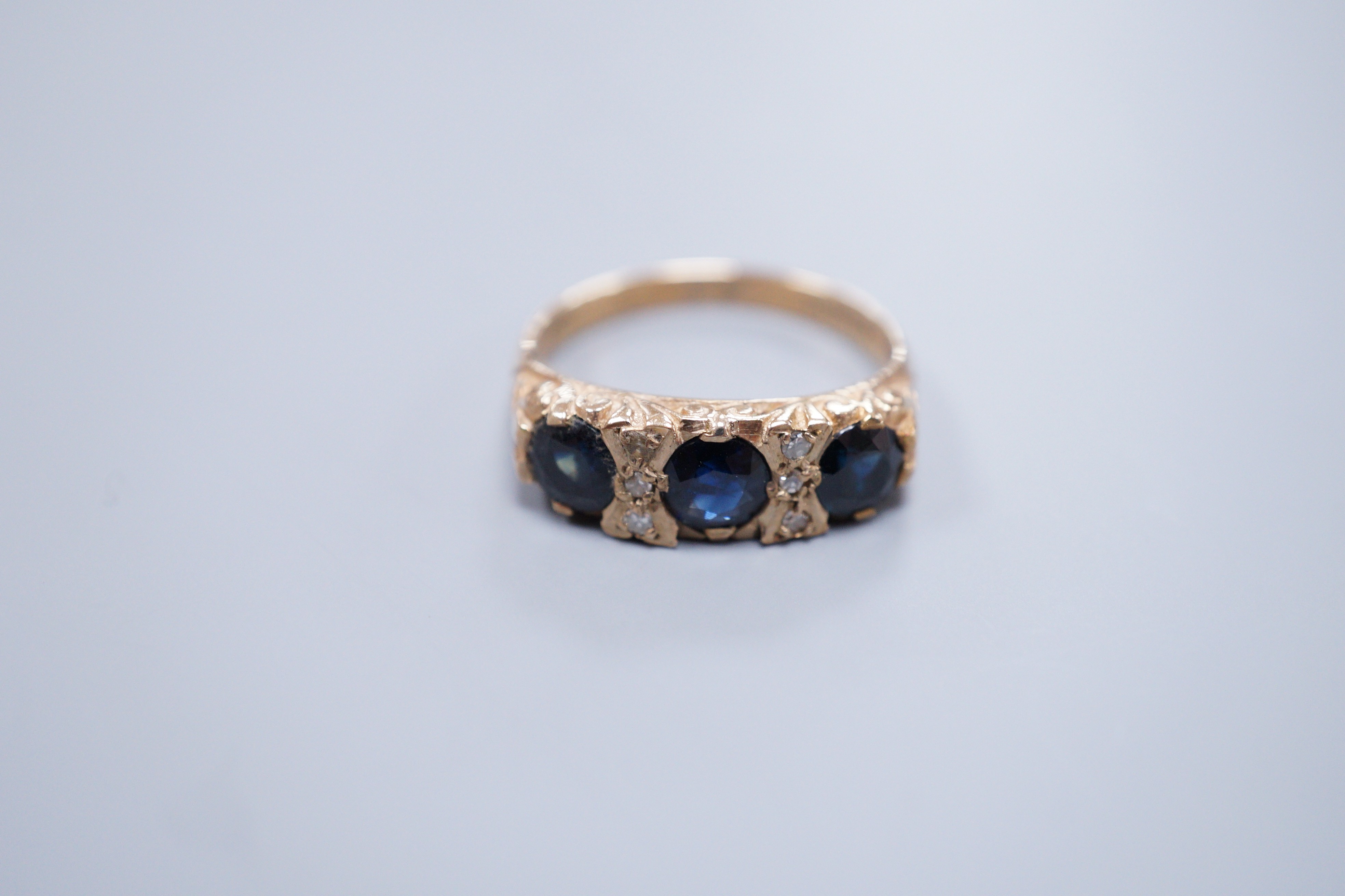 A 9ct gold sapphire and diamond half hoop ring, size O, gross 4 grams